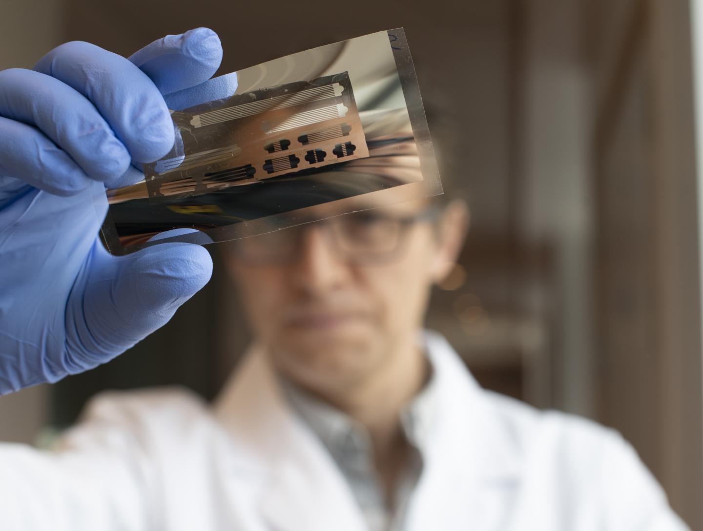 Dr Ross Hatton Examining a Patterned Metal