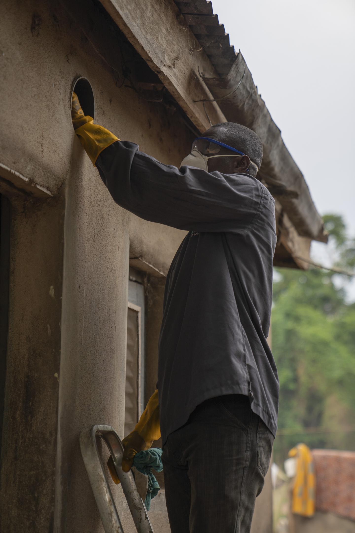 Man installing EaveTube in house