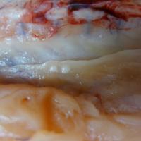 Photograph Showing Two White Cysts in a Salmon Fillet