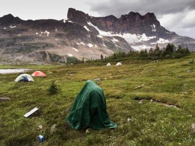 Akshay Mehra Flies a Drone, Wearing a Tarp. Salient Mountain, Canadian Rockies