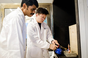 NTU Assoc Prof Aravind (left) with PhD student Dean Seah, doing fire tests on timber in the lab.