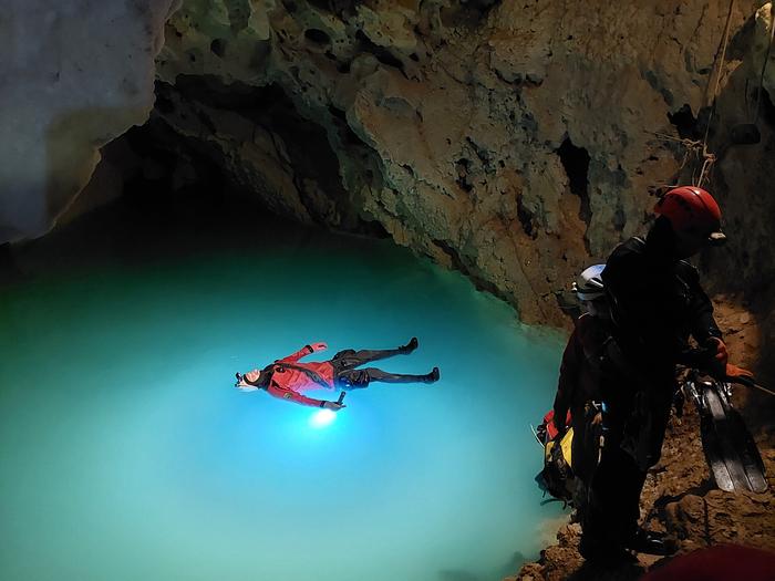 Cave diver floats in underground lake