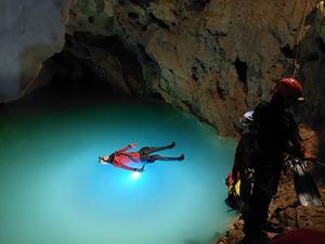 Cave diver floats in underground lake