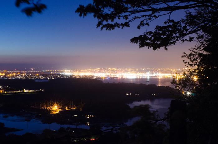 Street lighting creates an artificial glow in the night sky above Plymouth, UK