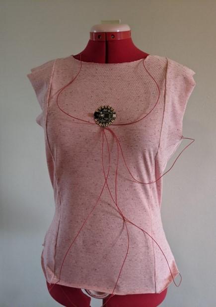 A Garment Sewn with Conductive Yarn, with Seams Connected by Wire to a Microcontroller