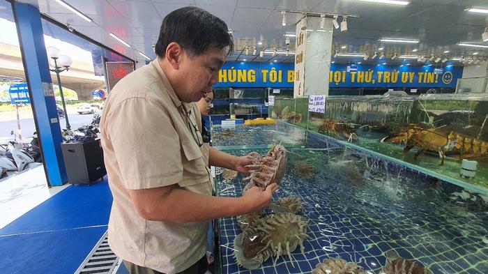 Prof. Peter Ng examining giant isopods from a seafood market