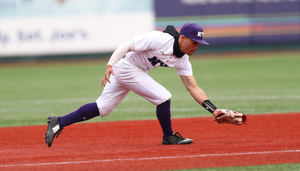 NYU Shortstop reaching for the baseball