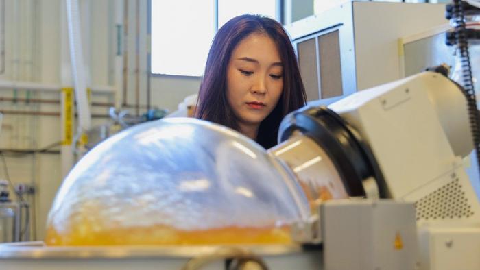 Fujunzhu Zhao, a Ph.D. student, works in Zhiwu "Drew" Wang's lab. Wang's team is working to convert food waste into sustainable bioplastics.
