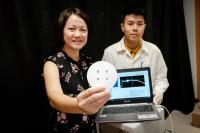 Ntu Assoc Prof Ling Xing Yi (Left) Holding Their Specially Designed Chip that Can Trap Gas Molecules