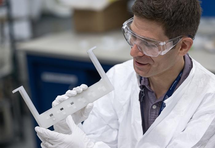 Eric Lechner with accelerator material samples