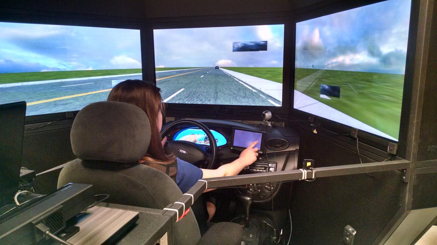 A Volunteer Demonstrates the Driving Simulator