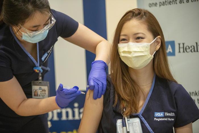 Health care worker receives vaccine