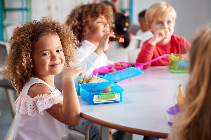 Young children eating lunch at school.