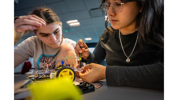 Students make careful adjustments to their vehicle