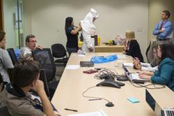 Experts Train on Donning and Removing PPE