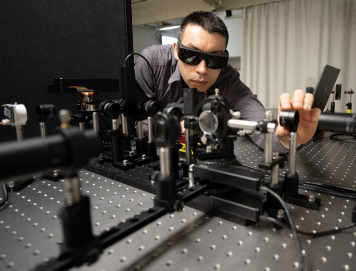 Researcher with optical setup