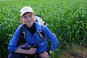 Ruby Hume taking soil measurements in the field.