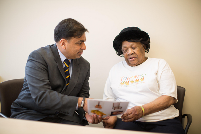 Joe Verghese, M.B.B.S., M.S., (pictured with study participant)