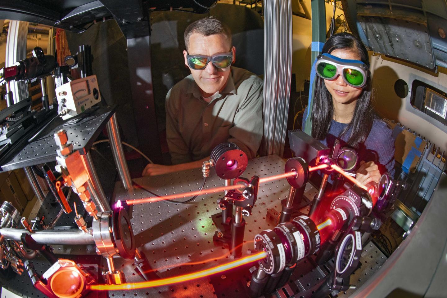 Sandia National Laboratories engineers observe a laser .