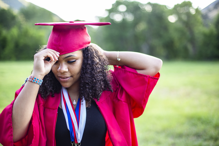 Student holding cap