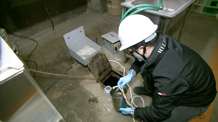 Collecting samples at a wastewater treatment plant