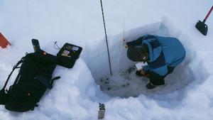 Christopher D'Ambroise checking a snow pack