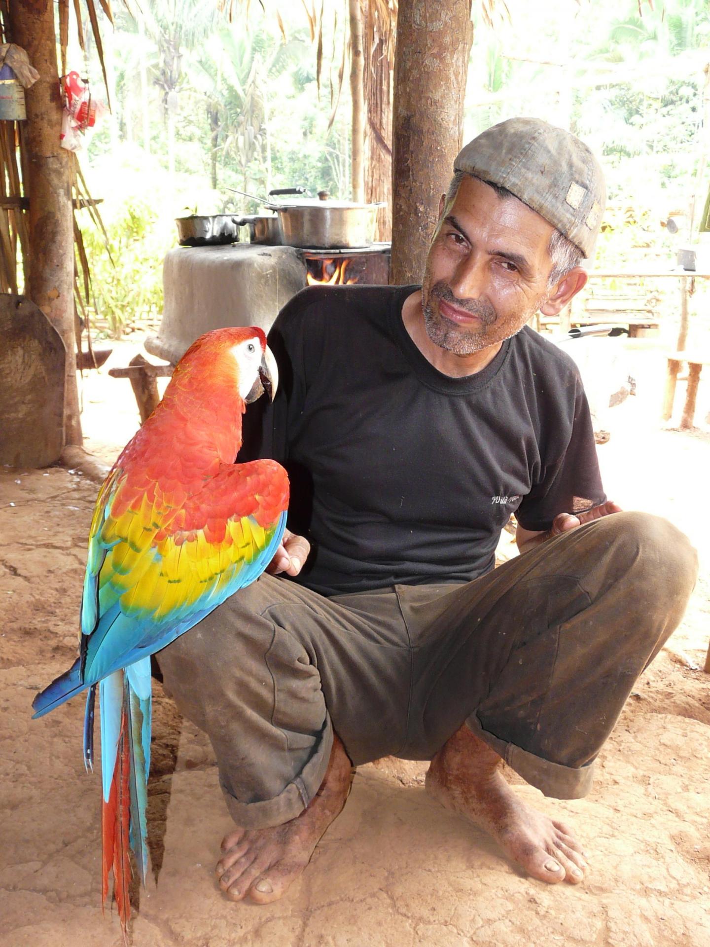 Local Farmer with a Scarlet Macaw