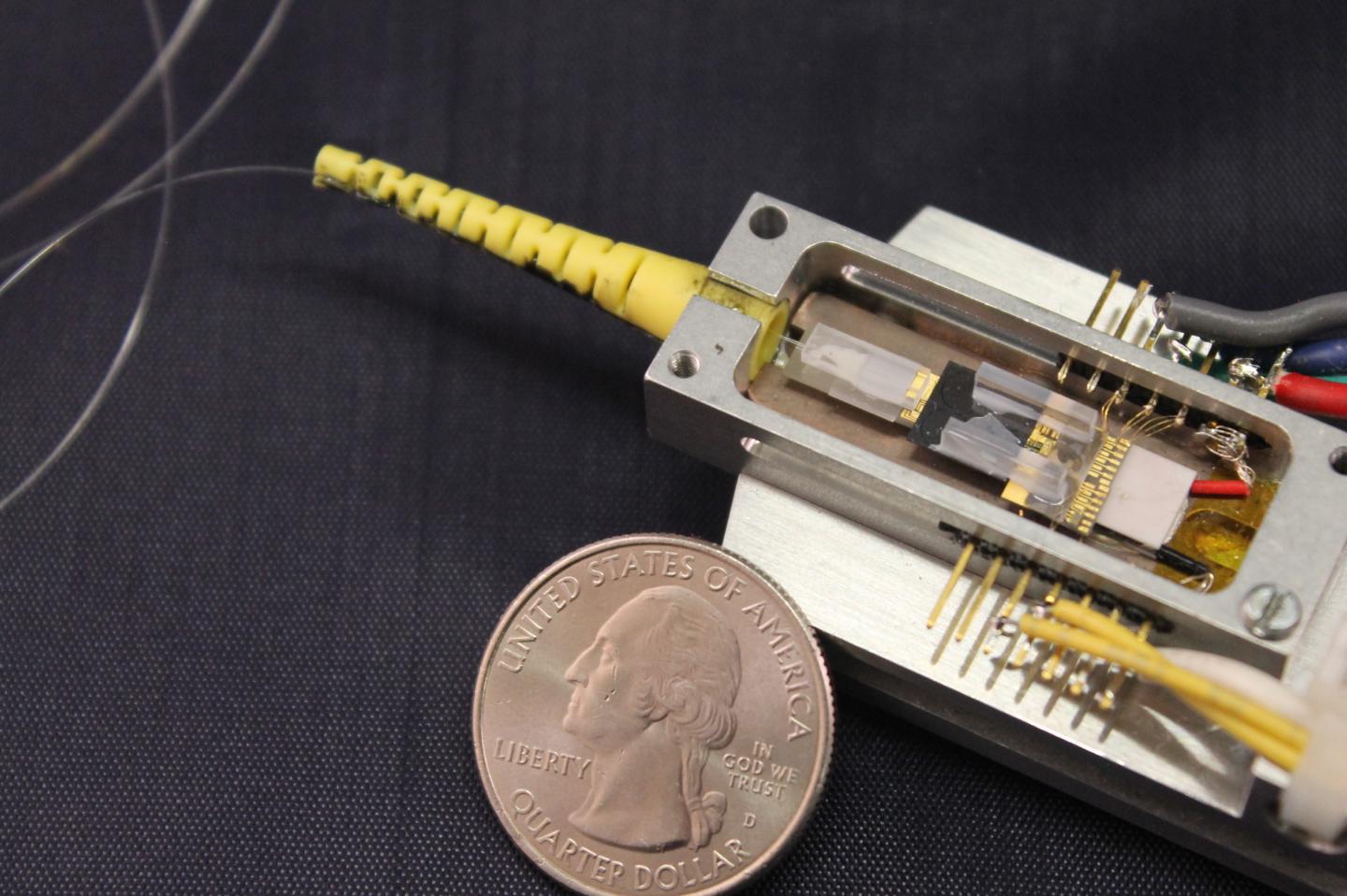 Compact Silicon-Nitride Integrated Soliton Microcomb Chip Device in a Butterfly Package with a Fiber