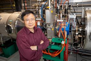 Yun Liu of ORNL stands before laser comb