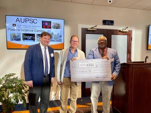 Associate Dean for Research and Graduate Studies Mark Liles, Brian Counterman and COSAM Dean Edward E. Thomas, Jr. pose with a check to show that Counterman from the Department of Biological Sciences won the event's logo contest.