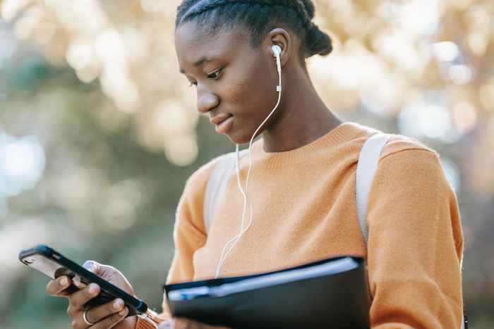 Young woman looking at her cell phone