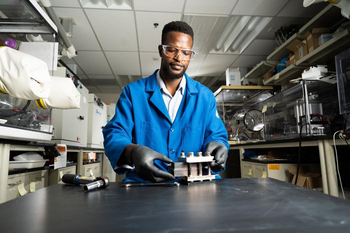 Lead author and battery researcher Gabriel Nambafu assembles a test flow battery apparatus