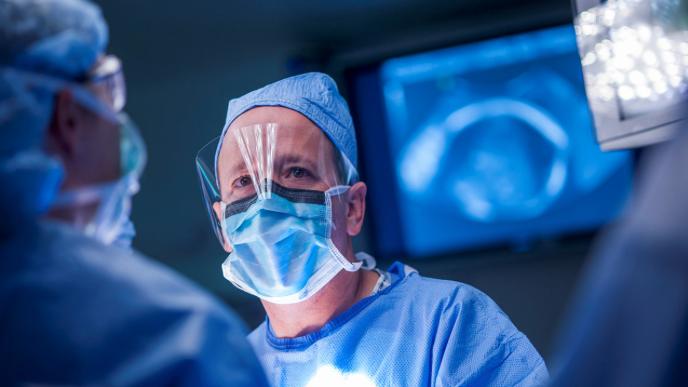 Dr. Henry Galan Wearing Protective Eyewear and a Face Mask During Surgery