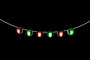 Christmas-color droplets cling to a wire