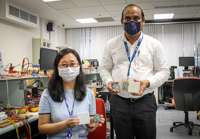 LITE-ON Singapore researcher Ms An Ping and NTU Lead Principal Investigator Mr Nirupam S D, holding an early design of a smart energy device