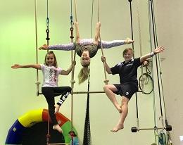 A Trio of Kids Hanging out on the Trapeze