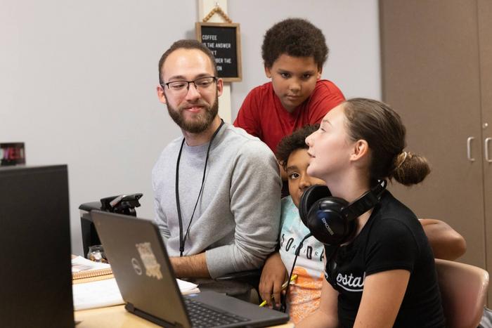 College of Community and Pubic Affairs student Derek Mendoza and middle schoolers