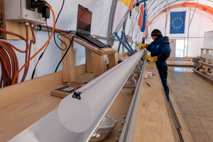 A freshly drilled ice core is measured.