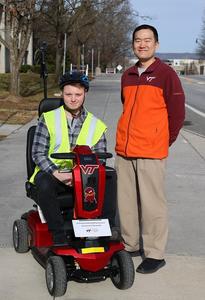 (From left) Keegan Miller, an undergraduate researcher in geography, and Junghwan Kim with a scooter that was used to capture street-level images.