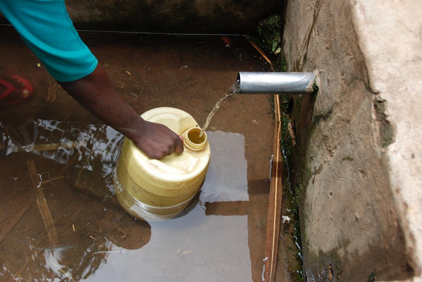 Drawing from a Water Source in Rural Kenya