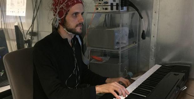 Researcher Andrew Goldman on Piano with EEG Cap