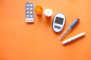 Insulin pen, diabetic measurement tools and pills.