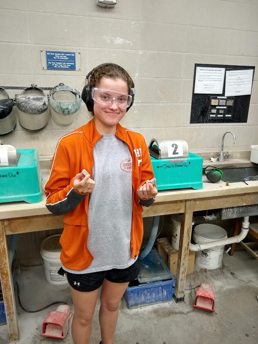 Undergraduate researcher with stone samples