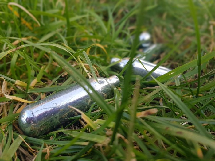 Empty nitrous oxide dispensers in London park