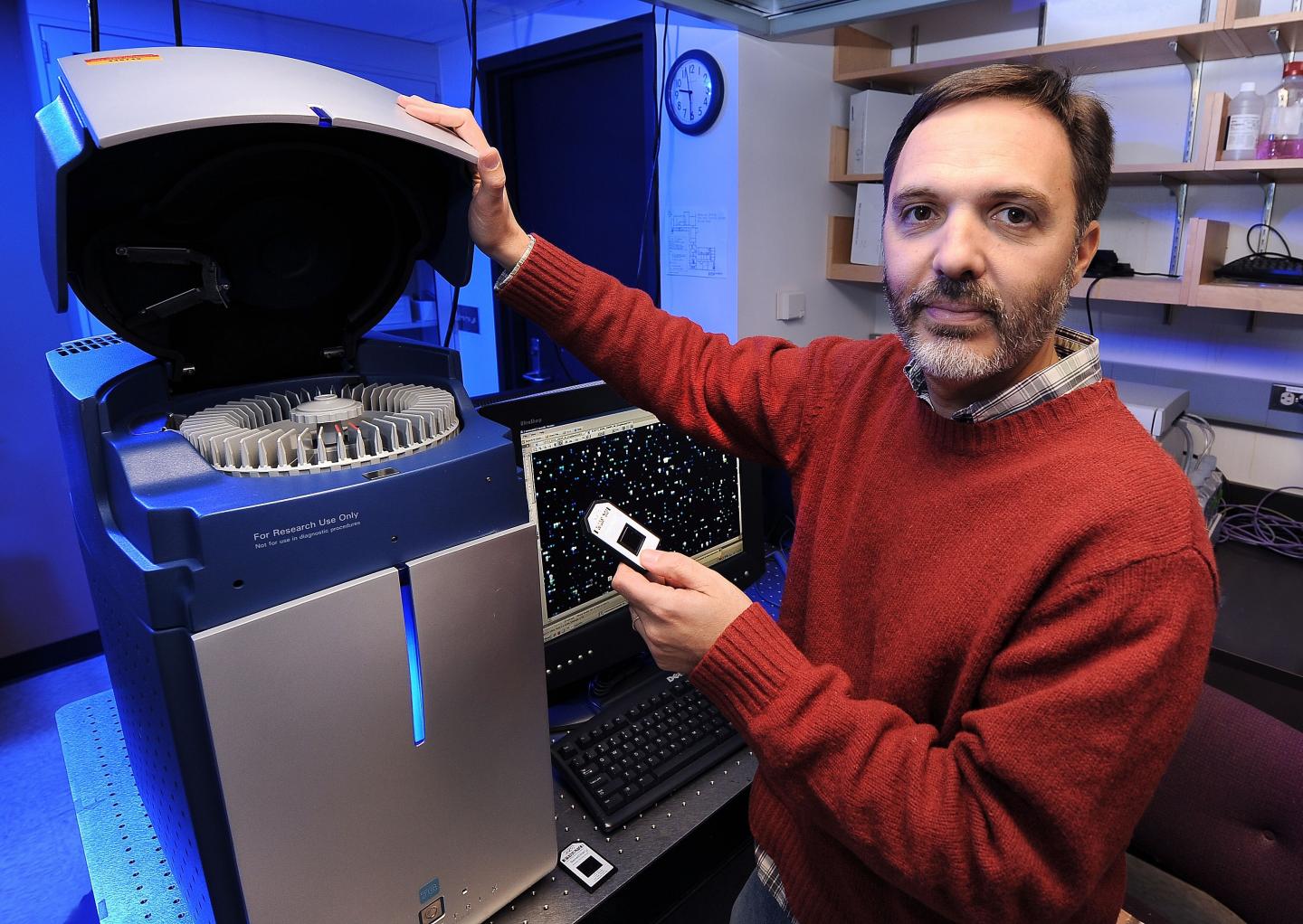 Gustavo MacIntosh works with computer equipment in a lab at Iowa State University
