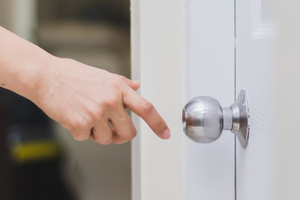 Person pausing before touching door handle