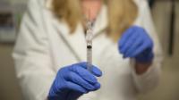 Clinician Holding Vaccine Syringe