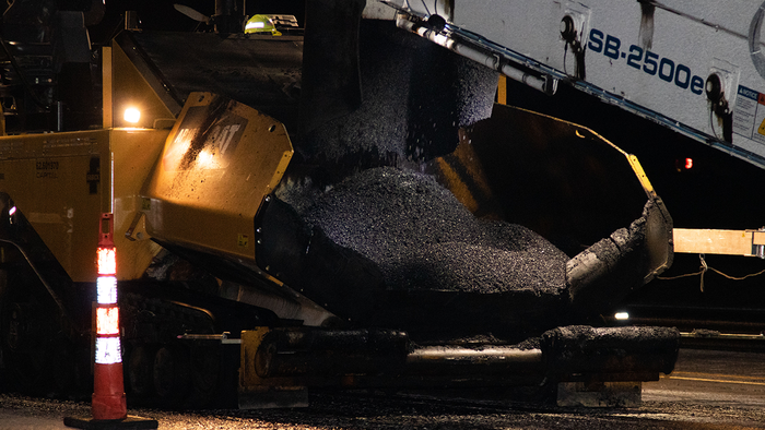 Pavement mixture being applied to road surface