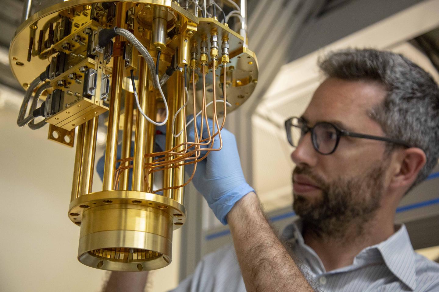 Professor John Morton next to a dilution fridge