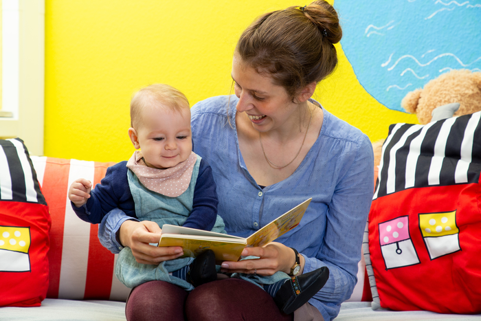 Mother and child engaging in shared book reading